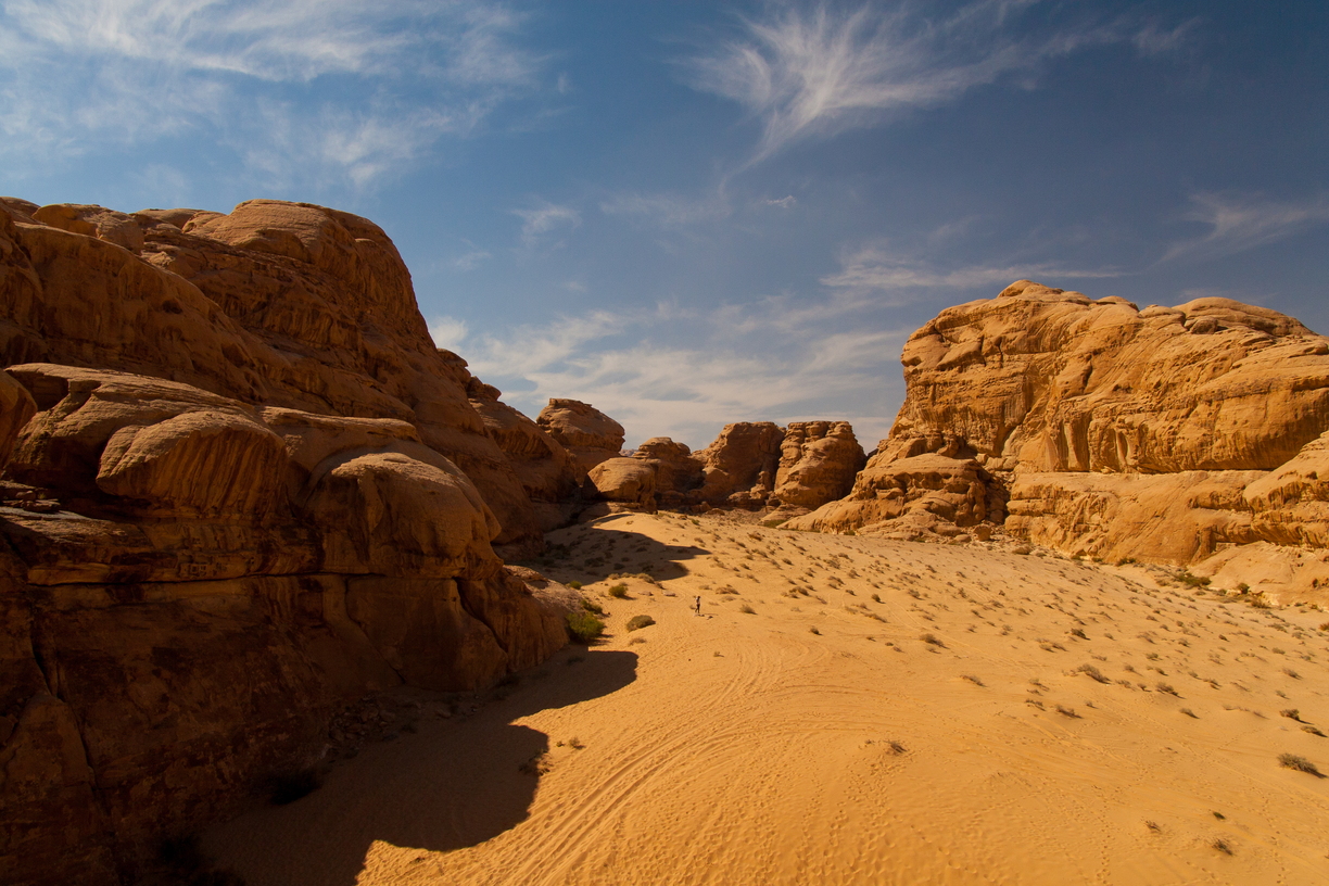 People disappear amongst the sandstone blocks of Wadi Rum, Jordan.